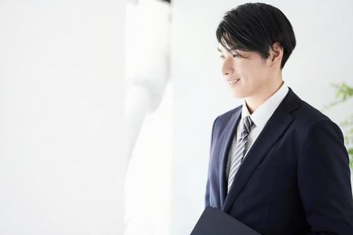 Japanese male businessman looking out the window with a smile, a smile, male, businessman, JPG