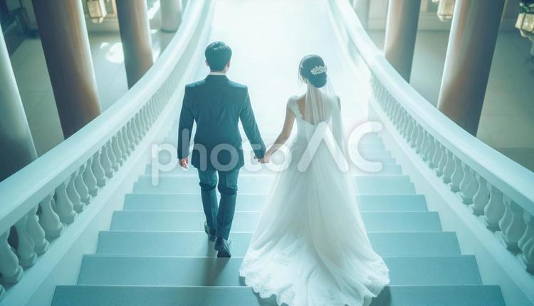 手をつないで階段を上っていく新郎新婦 ウェディング,花嫁,花婿の写真素材