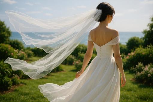 白いベールをなびかせる花嫁 白いベールをなびかせる花嫁の写真