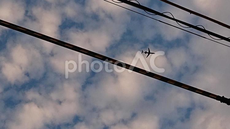 電線と飛行機 電線,雲,空の写真素材