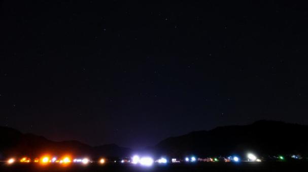 山影に輝く街明かりと星空 山影に輝く街明かりと星空 街明かり,山,星の写真素材