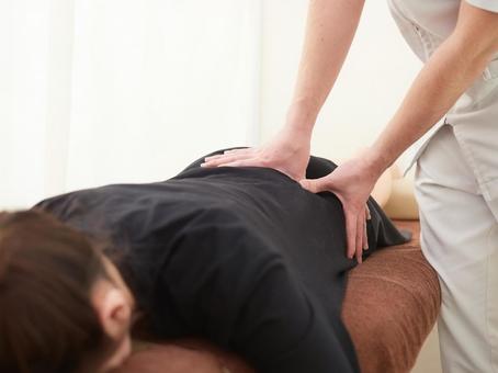 Japanese woman receiving a waist massage Japanese woman receiving a waist massage