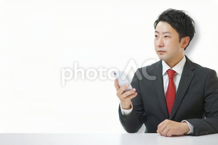 スマホを持っているビジネスマン ビジネス,会社,ビジネスシーンの写真素材