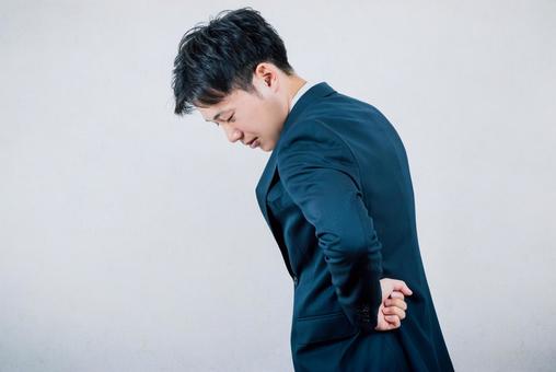 腰を痛めた会社員男性 腰痛,腰,ぎっくりの写真素材