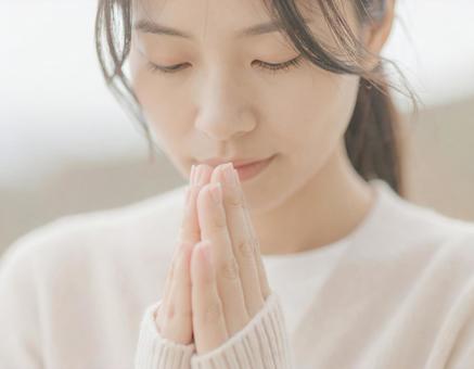 手を合わせる女性 手を合わせる女性の写真