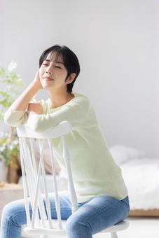 Young woman sitting across a chair, JPG Young woman sitting across a chair, JPG