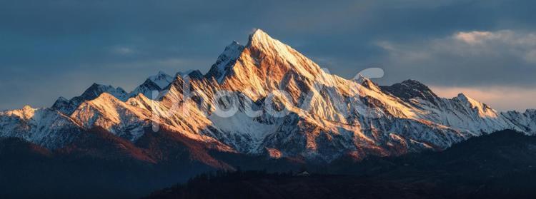 雪山を染める夕暮れの光：壮大な自然の風景 山,雪山,雪の写真素材