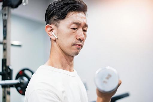 A man doing muscle training with dumbbells A man doing muscle training with dumbbells