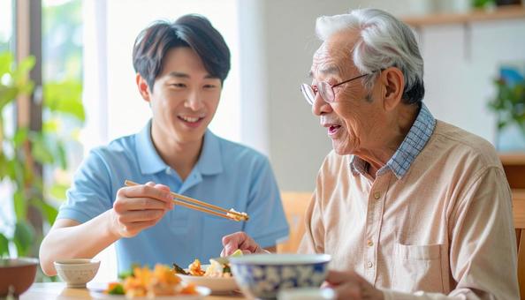 食事介助をする男性介護士と高齢男性 食事介助をする男性介護士と高齢男性の写真