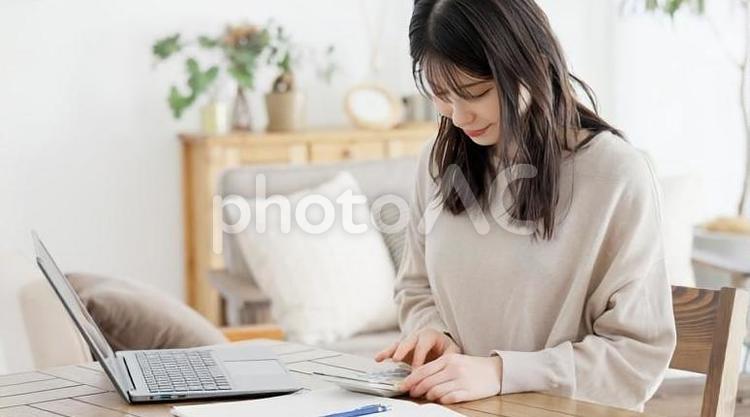費用を電卓で計算する女性 女性,電卓,費用の写真素材