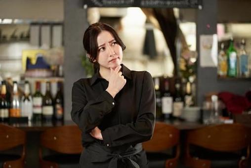 Asian female worried at a restaurant Asian female worried at a restaurant