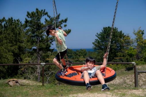 <Material> Brothers playing happily together in the park and blue sky, JPG