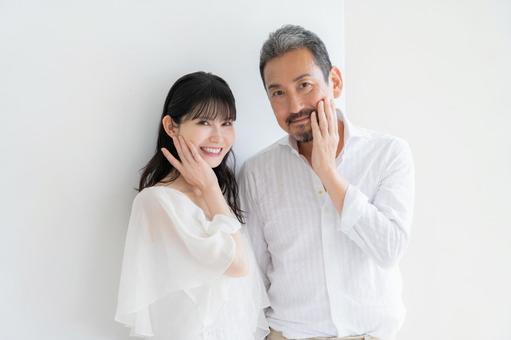 リビングでスキンケアをするミドルの夫婦 リビングでスキンケアをするミドルの夫婦 ビューティー,家族,夫婦の写真素材