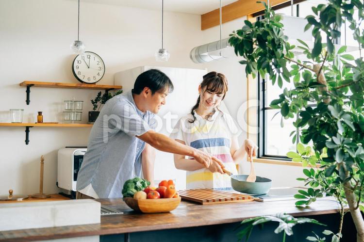 一緒に料理を作る男女（夫婦） 家事分担,料理,共働きの写真素材