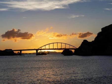 夕焼けの光が差し込む伊計大橋の風景 夕焼けの光が差し込む伊計大橋の風景の写真