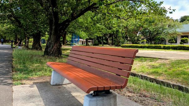 木陰にある公園のベンチ 木陰にある公園のベンチの写真