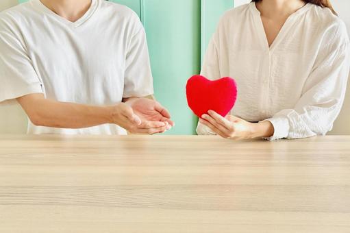 Image of a woman giving a heart to a man, JPG Image of a woman giving a heart to a man, JPG