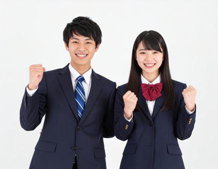 ガッツポーズでエールを送る男女高校生 ガッツポーズでエールを送る男女高校生の写真