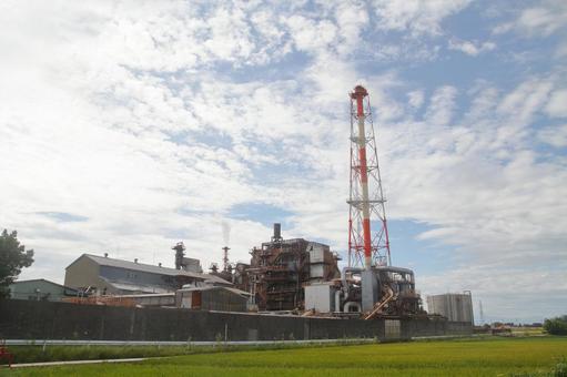 田舎のパルプ工場、富山県高岡市 煙突,田んぼ,越中パルプ工業の写真素材