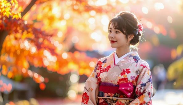 紅葉を眺める晴れ着姿の女性のポートレートの写真