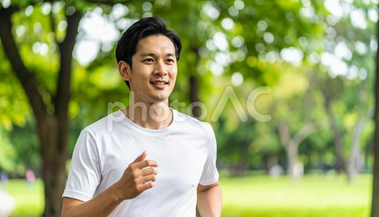 公園でジョギングをする笑顔の日本人男性 人物,男性,夏の写真素材