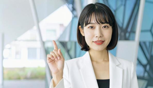 自信のある表情で指さすビジネス女性 自信のある表情で指さすビジネス女性の写真