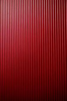 【背景素材】金属表面、赤色、縦の写真