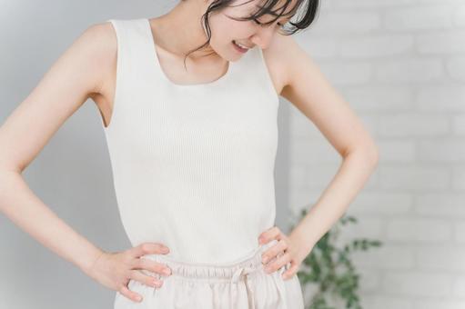 ウエストを気にするスリムな女性 ウエストを気にするスリムな女性 ダイエット,サイズダウン,ウエストの写真素材