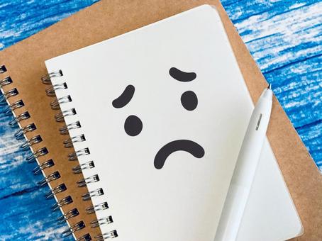 A ring notebook with a sad face or expression, sad, lonely, anxiety, JPG