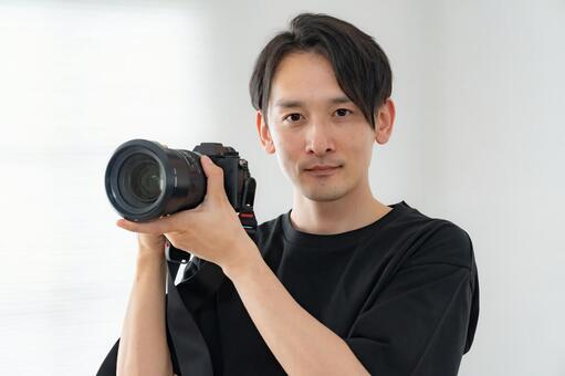 カメラマン 男性,大人,レンズの写真素材