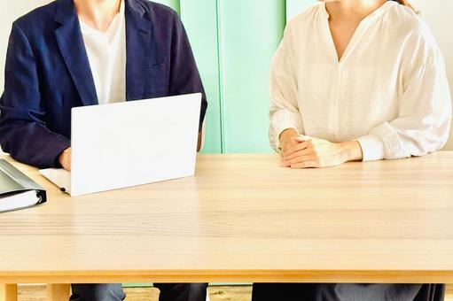 PCを見てカフェでミーティングする男女 仕事,悩む,相談の写真素材