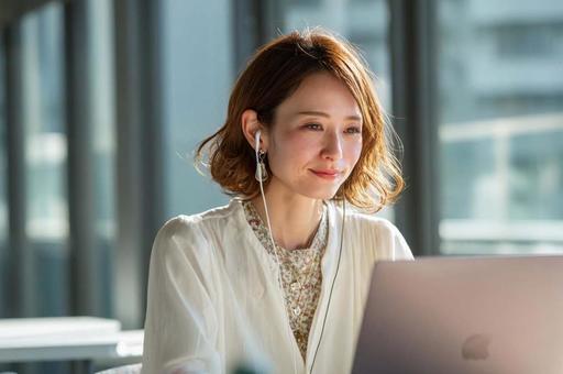 オンライン会議に参加する女性 オンライン会議に参加する女性の写真