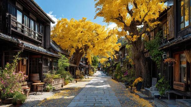 黄金のイチョウ並木と日本の街並みの写真