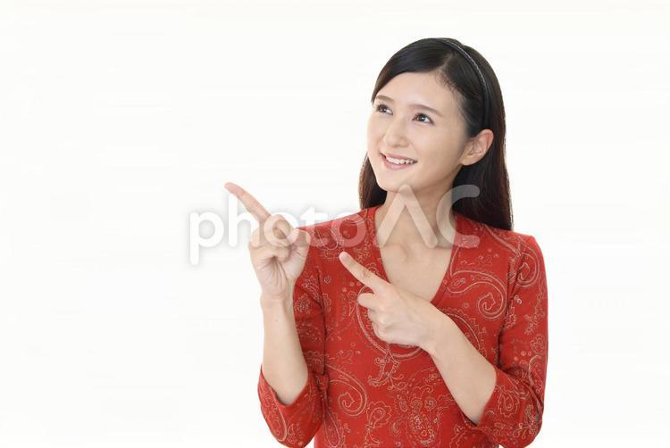 指さす笑顔の女性 女性,笑顔,案内の写真素材