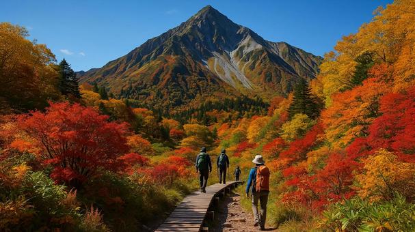 紅葉に彩られた登山道を歩く人達と山の風景 紅葉に彩られた登山道を歩く人達と山の風景の写真