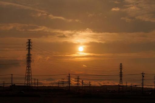 Electricity transmission tower illuminated by the setting sun, JPG