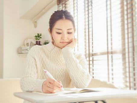 Image of a woman taking notes in a notebook, female, telework, work from home, JPG