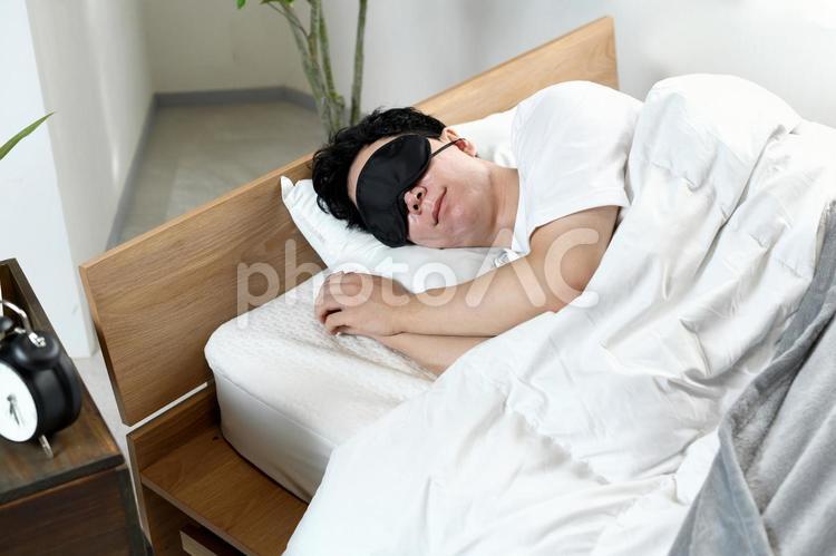 アイマスクをつけて寝る若いアジア人男性 睡眠,男性,快適の写真素材