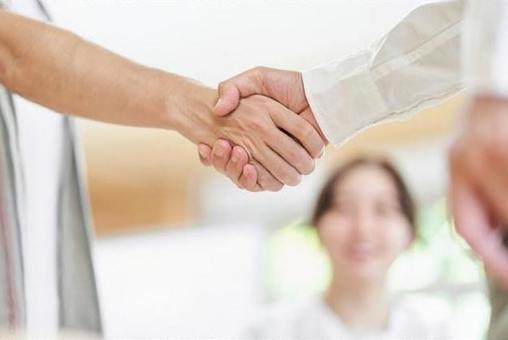 Young men and older men shaking hands Young men and older men shaking hands