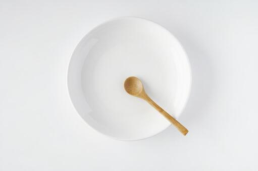 White plate and wooden spoon White plate and wooden spoon