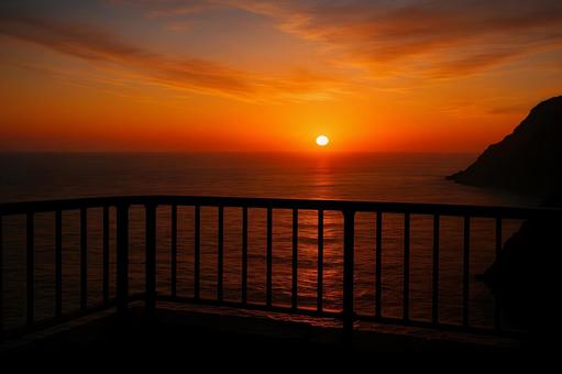 岬の夕日と欄干 岬の夕日と欄干の写真