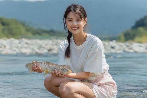 鮎をつかみ取りする女性 鮎をつかみ取りする女性の写真