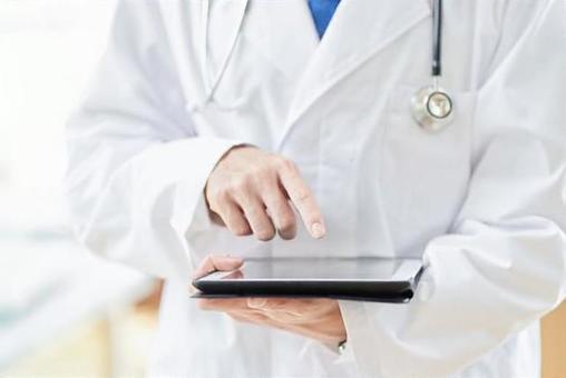 Male doctor operating a tablet Male doctor operating a tablet