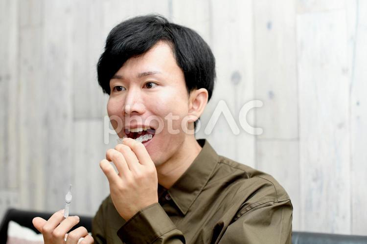 若い男性のホームホワイトニングのイメージ ホームホワイトニング,マウスピース,ホワイトニングの写真素材