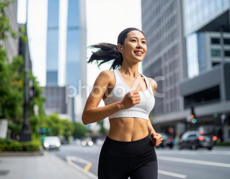 街中をジョギングする若い女性 女性,ジョギング,走るの写真素材