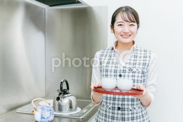 お茶をくむ会社員の女性 給湯室,お茶くみ,お茶当番の写真素材