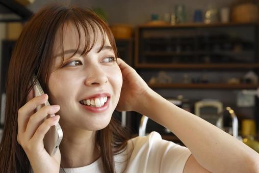 スマホで電話をする笑顔の女性 スマホ,通話,電話の写真素材