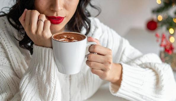 マシュマロココアを飲む白いセーターの女性 マシュマロココアを飲む白いセーターの女性の写真