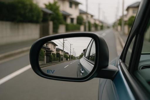 サイドミラーに映る街並みと車の後方風景 サイドミラーに映る街並みと車の後方風景の写真
