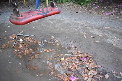 Mud and fallen leaves, swings in the park after the rain, JPG